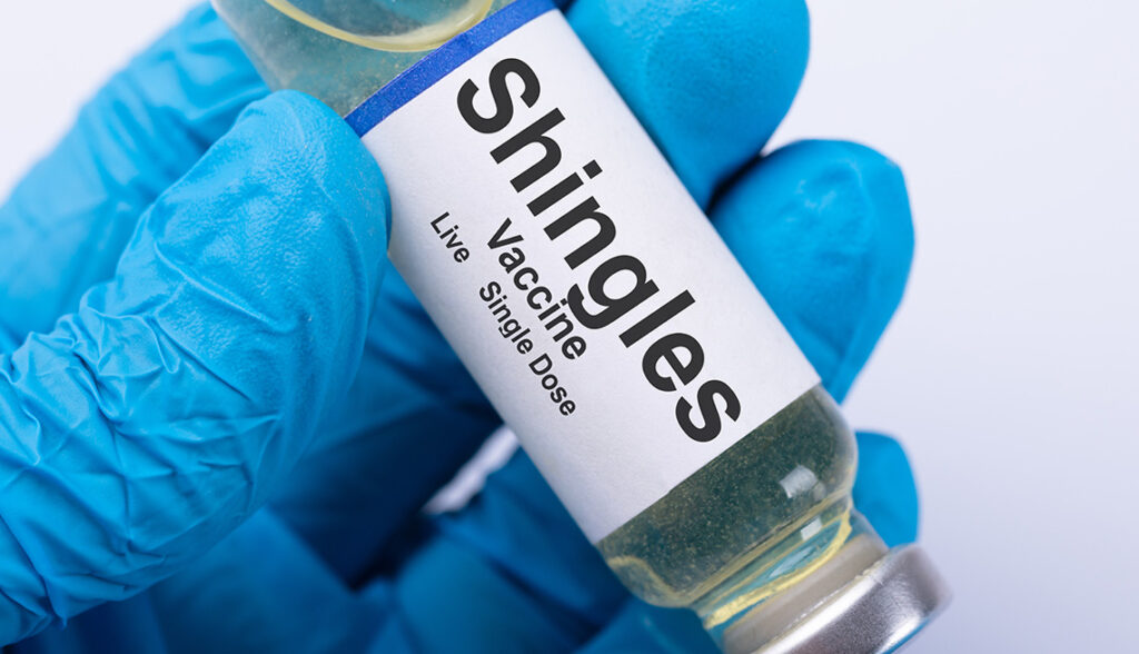 doctor filling shingles vaccine syringe