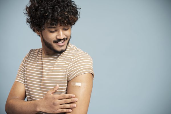 young man getting vaccinated young man getting vaccinated